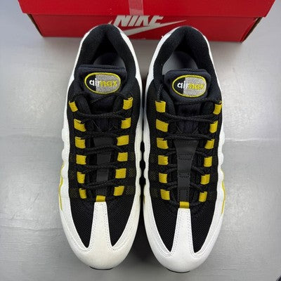Nike trainers white with black and saffron accents, featuring iconic Air Max bubble sole.