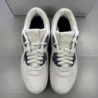 Nike trainers white with black snakeskin pattern and logo detail.