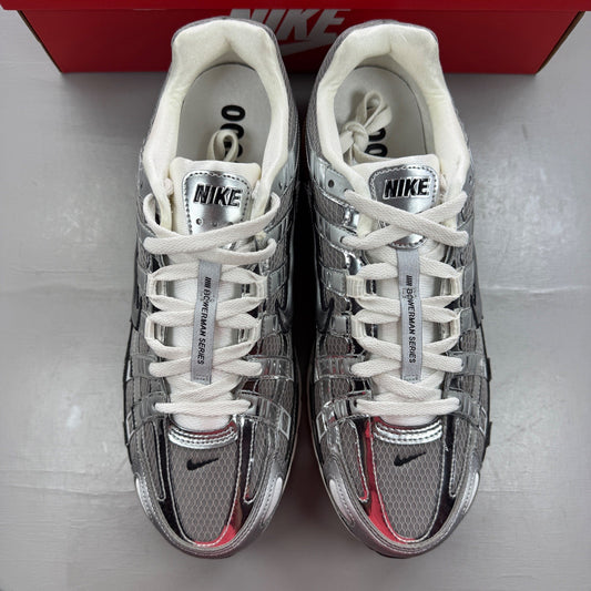 Nike deck shoes metallic silver with black and white accents, featuring logo details.