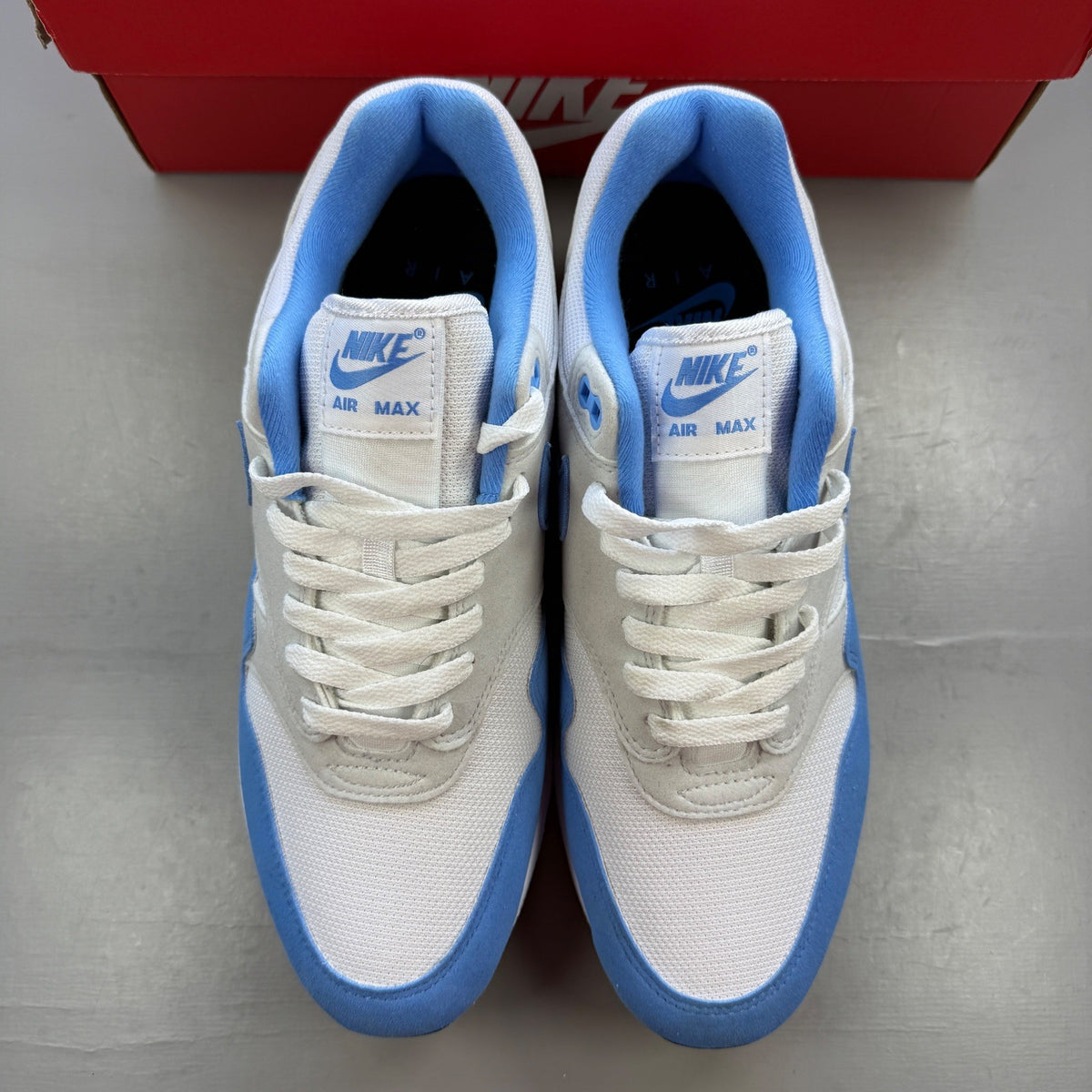 Nike running shoes blue with white accents and Air Max cushioning.