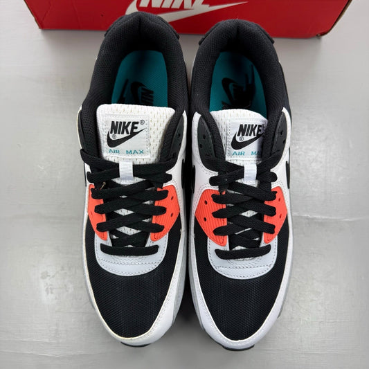 Nike black trainers with turf orange and white accents, featuring iconic Air Max design.