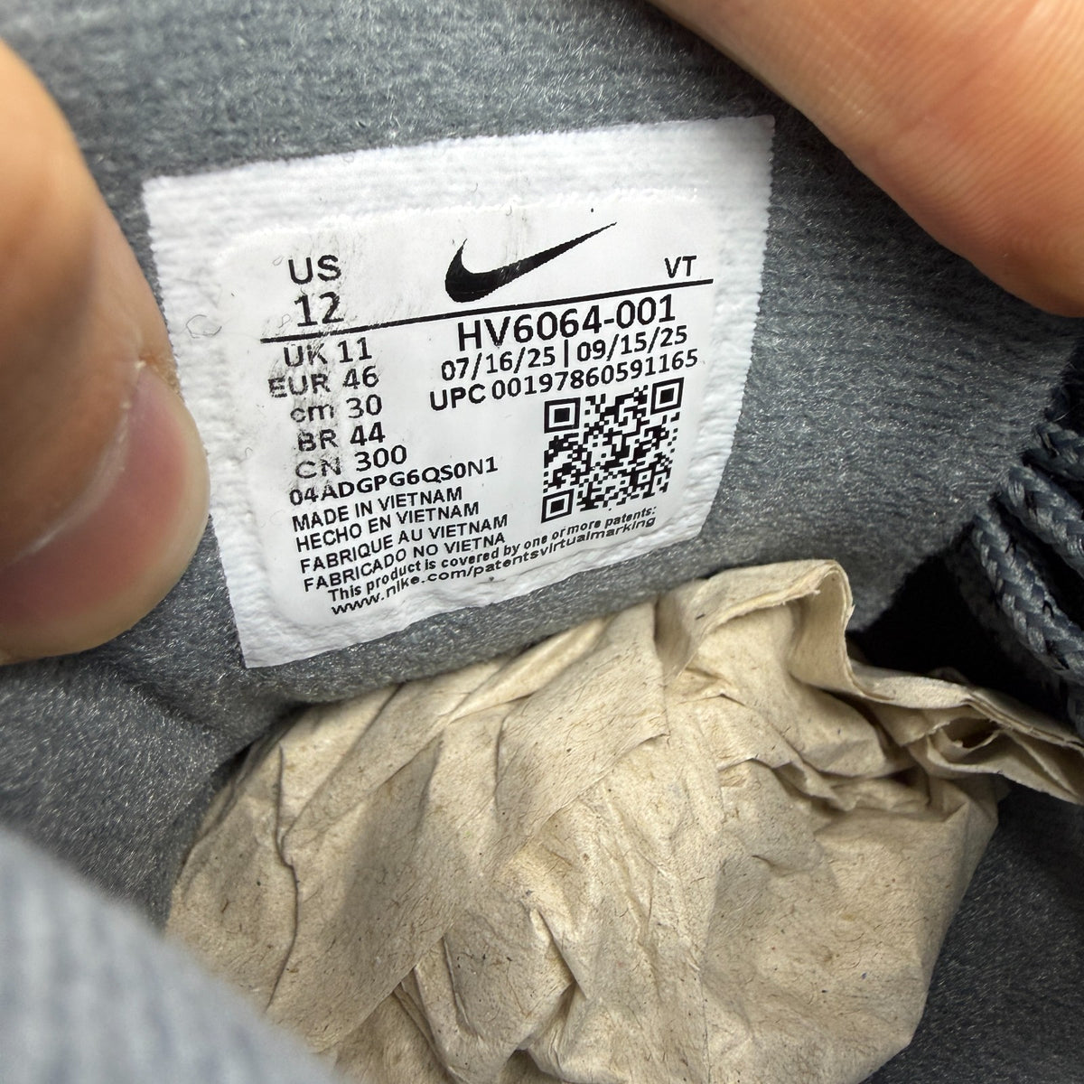 Nike running shoes grey with caution strip detailing and Air Max cushioning.