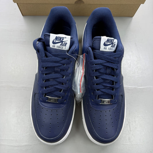 Nike trainers white with midnight navy accents and classic swoosh logo.