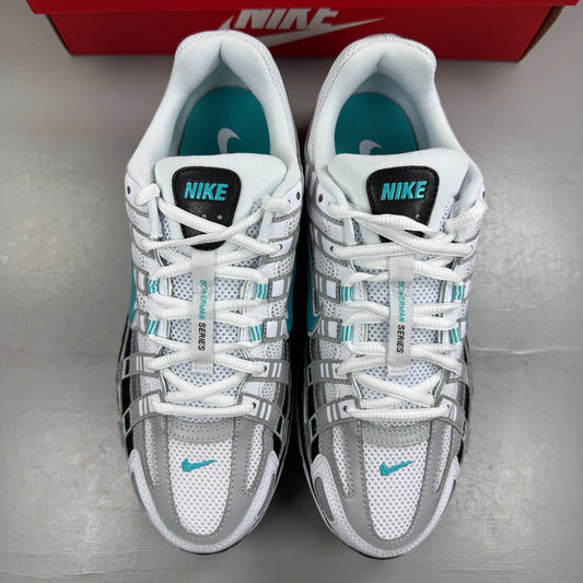 Nike white athletic shoes with dusty cactus accents and mesh upper details.