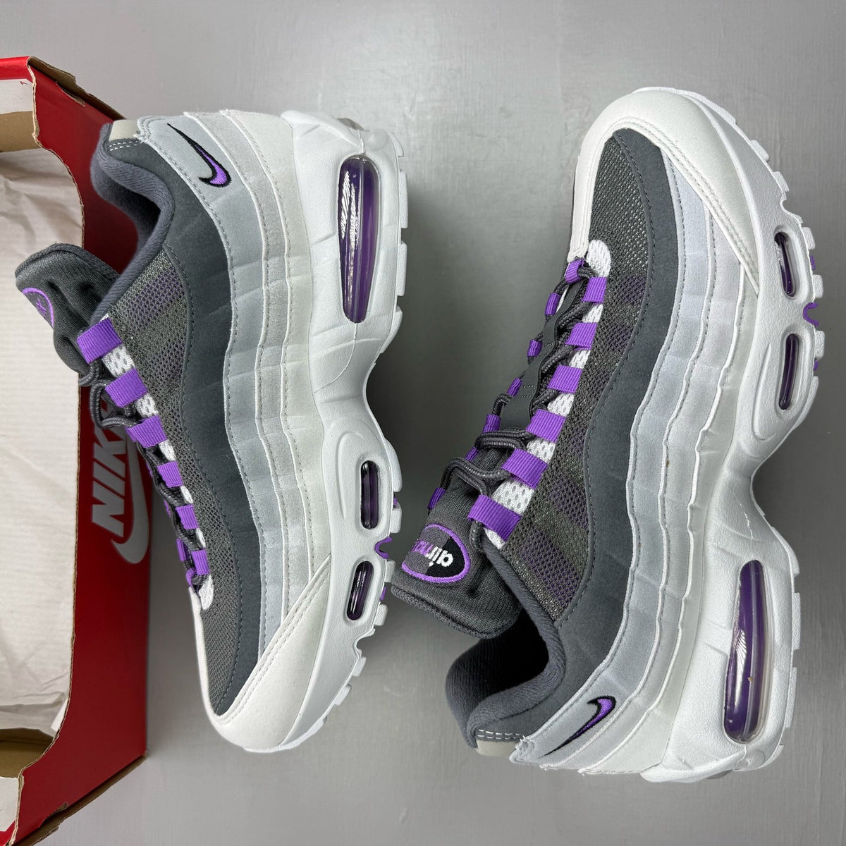 Nike Air Max 95 grey trainers with big bubble sole and logo detailing.