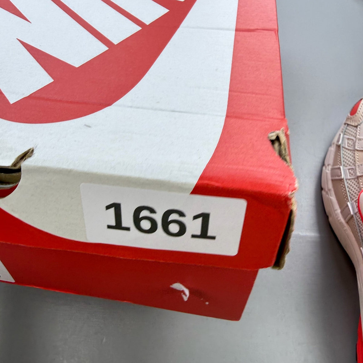 Nike P-6000 trainers white with red accents and mesh detailing, brand logo on tongue.