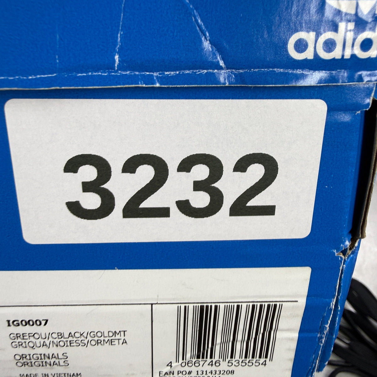 Adidas grey skate shoes with black accents and logo detail on tongue.