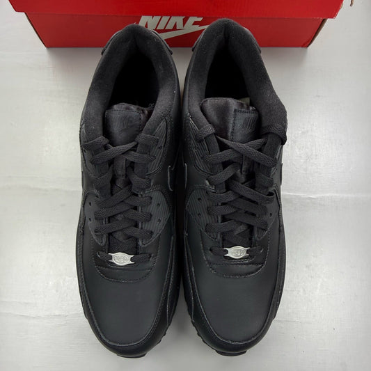 Nike black trainers leather upper with Air Max cushioning and logo detail.
