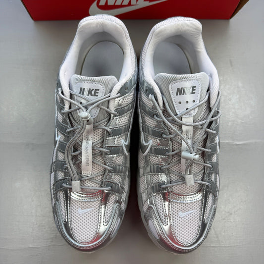 Nike deck shoes silver with logo details and sleek design.