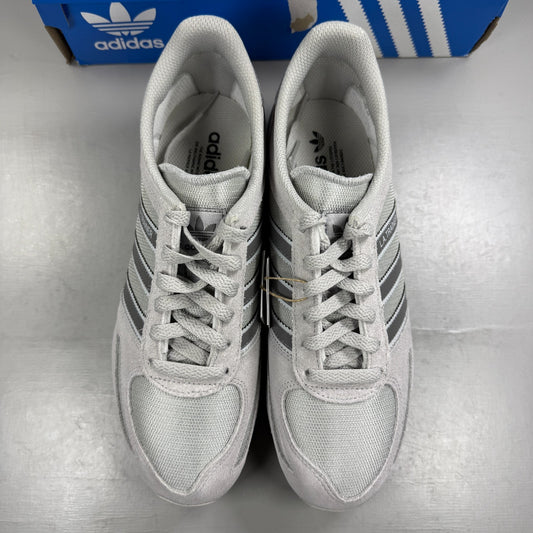 Adidas grey athletic shoes with white accents and classic three-stripe logo.