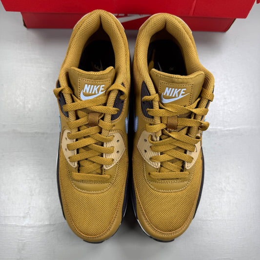 Nike black trainers with muted bronze accents and Air Max cushioning design.