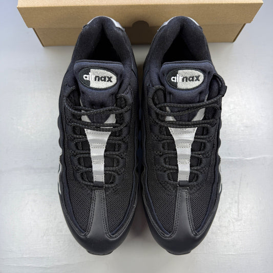 Nike trainers black with metallic silver accents and signature Air Max cushioning.