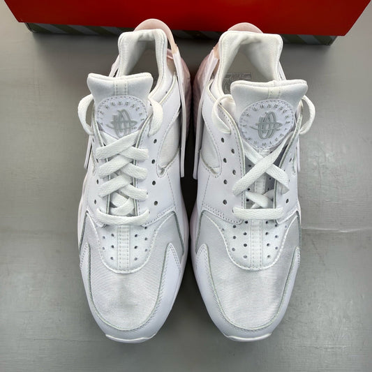 Nike Air Huarache white trainers with textured upper and signature logo detail.
