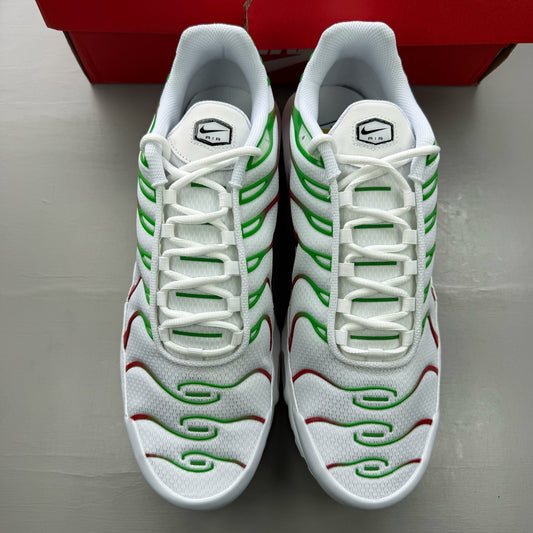 Nike Air Max Plus TN white trainers with green and red accents, featuring iconic logo.