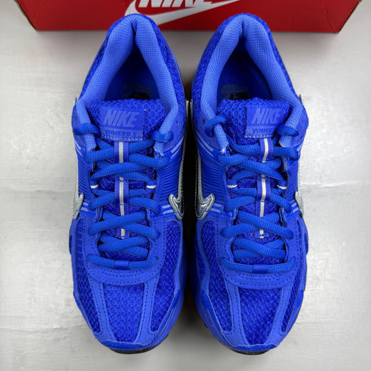 Nike Zoom Vomero 5 blue trainers with silver accents and logo details.