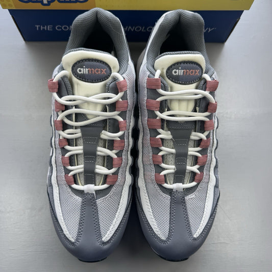 Nike Air Max 95 grey trainers with red accents and white sole, featuring iconic logo.
