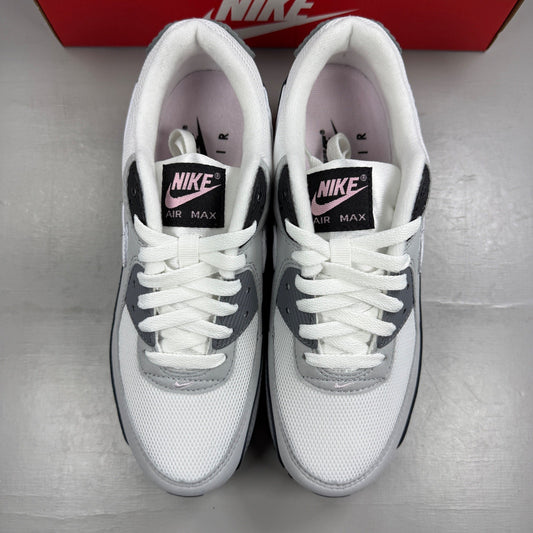 Nike Air Max 90 grey trainers with pink accents and white sole, featuring logo detail.