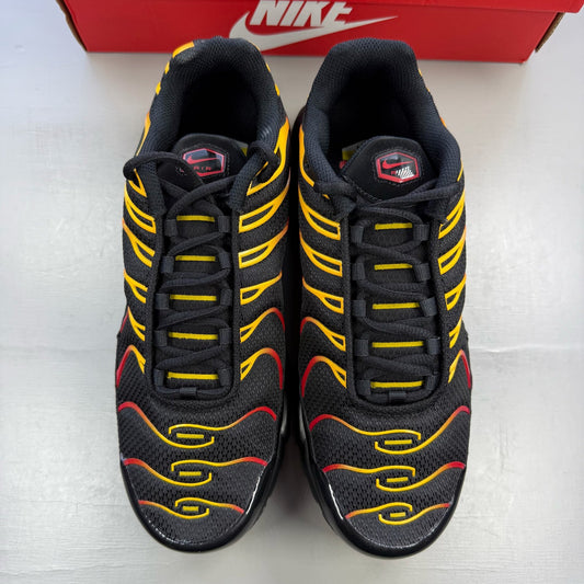 Nike Air Max Plus TN black with university gold and red accents, featuring iconic logo.