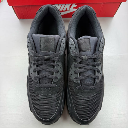 Nike Air Max 90 black trainers with sleek design and iconic logo.