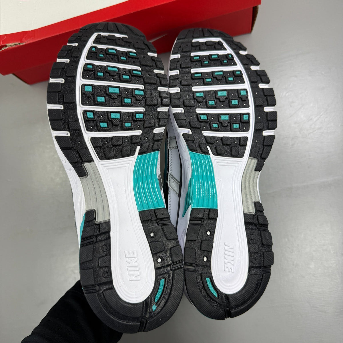 Nike white athletic shoes with dusty cactus accents and mesh upper details.