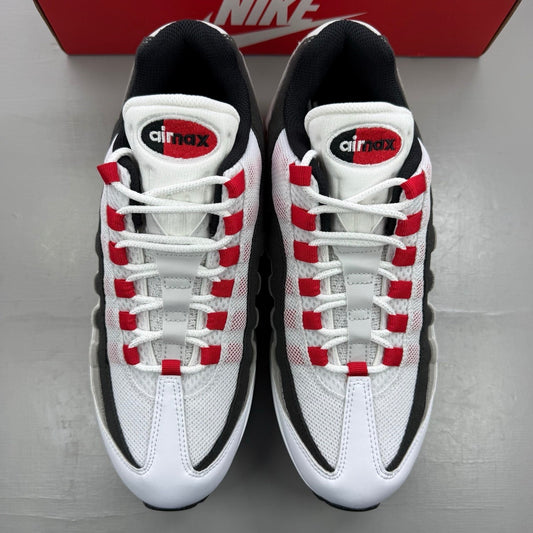 Nike trainers white with red accents and iconic Air Max bubble sole.