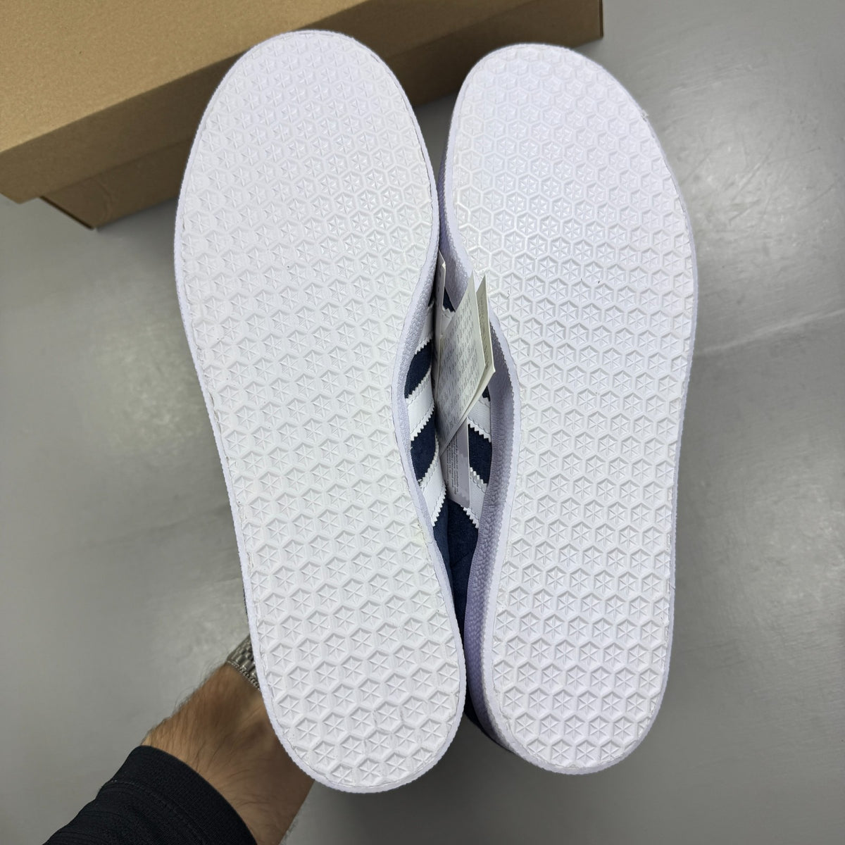 Adidas blue suede trainers with white stripes and logo detail.