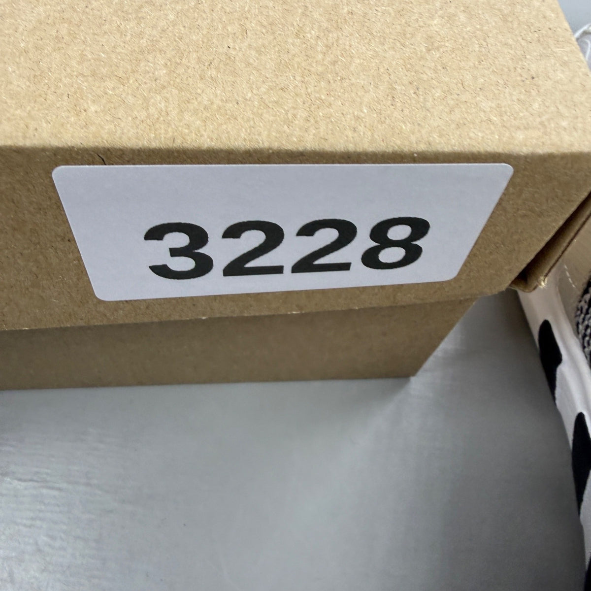 Adidas grey athletic shoes with mesh upper and signature three stripes logo.