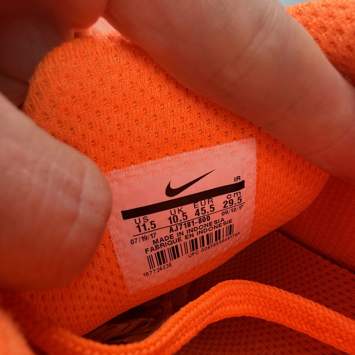 Nike Air Max Plus trainers total orange with large logo and mesh material.