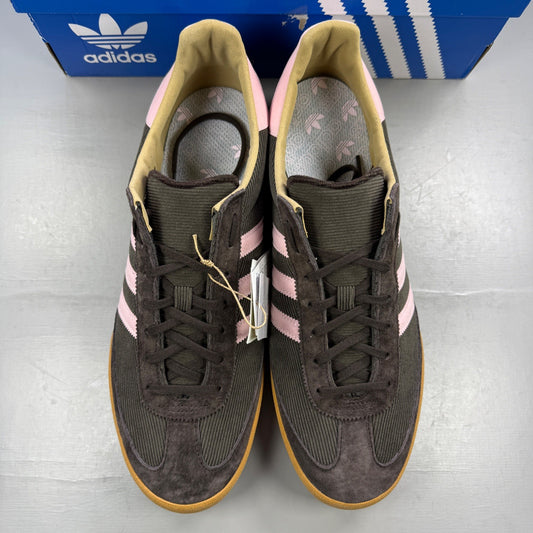 Adidas brown athletic shoes with pink accents and logo detail.