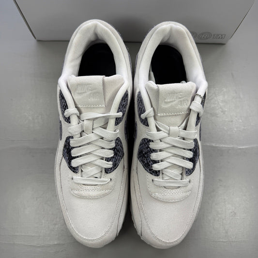 Nike trainers white with black snakeskin pattern and signature swoosh logo.