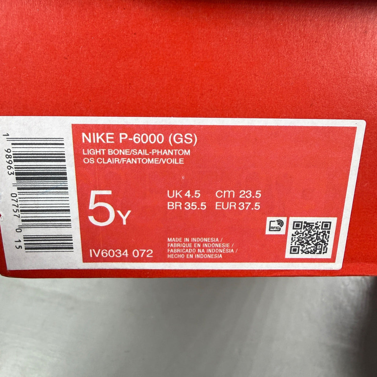 Nike beige athletic shoes with white accents and light bone detailing.