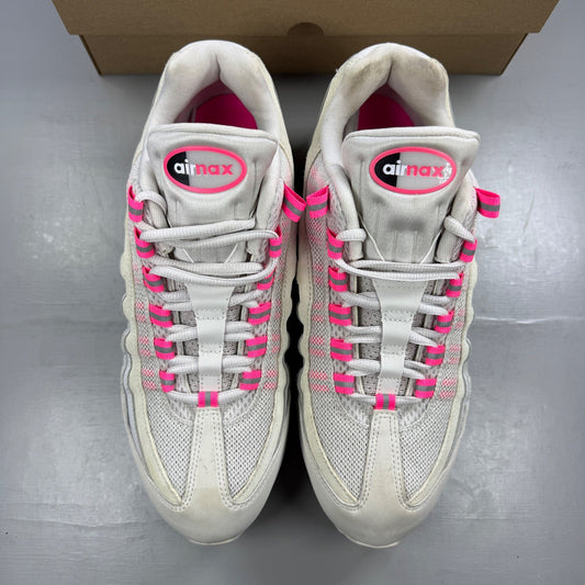 Nike running shoes white with pink accents and visible logo details.