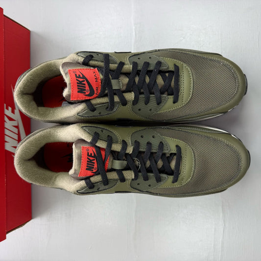 Nike Air Max 90 green trainers with black accents and classic logo detail.