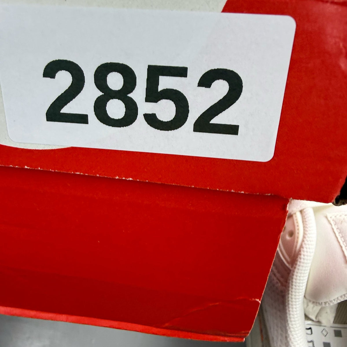 Nike Air Max 90 beige trainers with premium material and iconic logo detail.