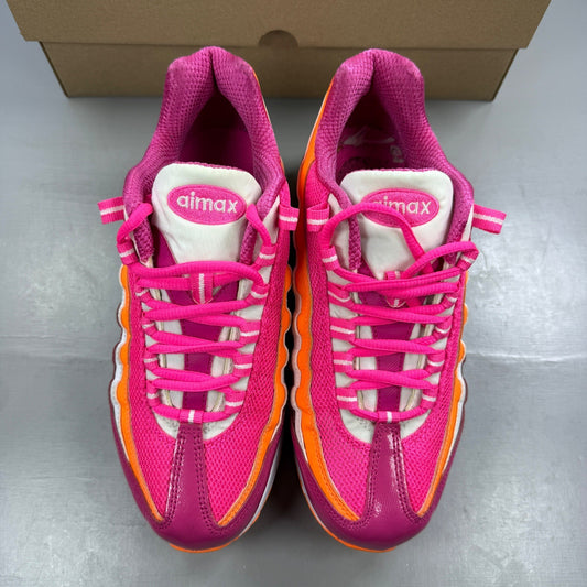 Nike running shoes vivid pink and white with mesh upper and Air Max cushioning.