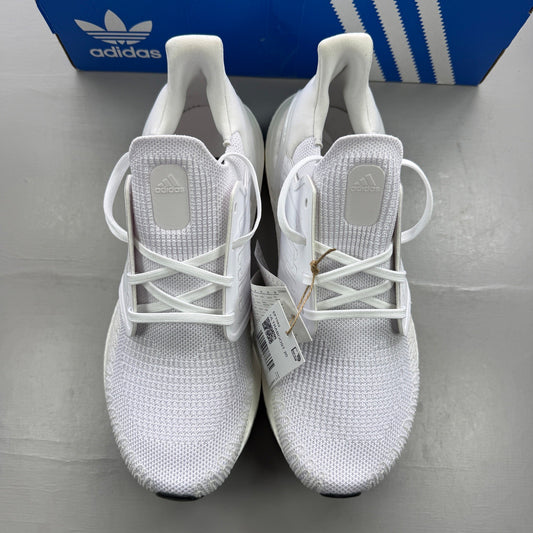 Adidas white trainers with Boost cushioning and iconic three-stripe logo.