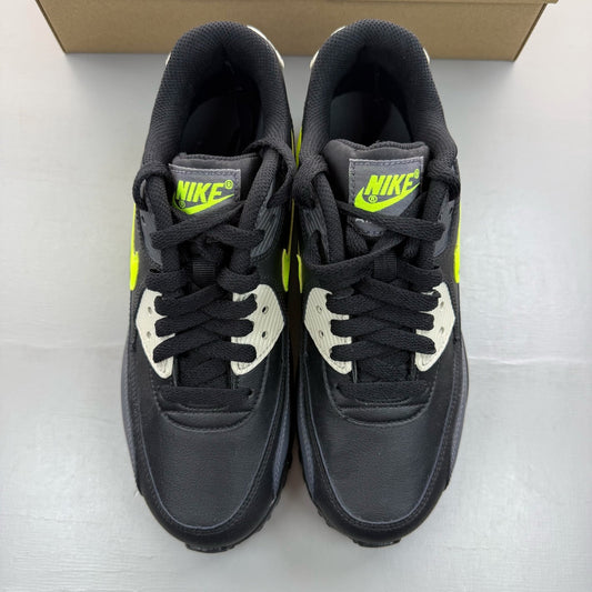 Nike Air Max 90 black trainers with volt accents and signature logo detailing.
