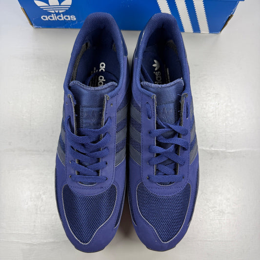Adidas blue trainers with black accents and signature three-stripe logo.