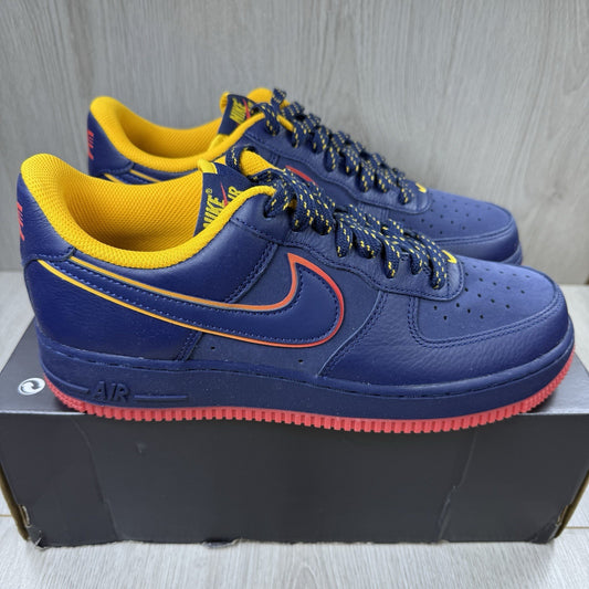 Nike blue trainers with gold accents and retro design elements.