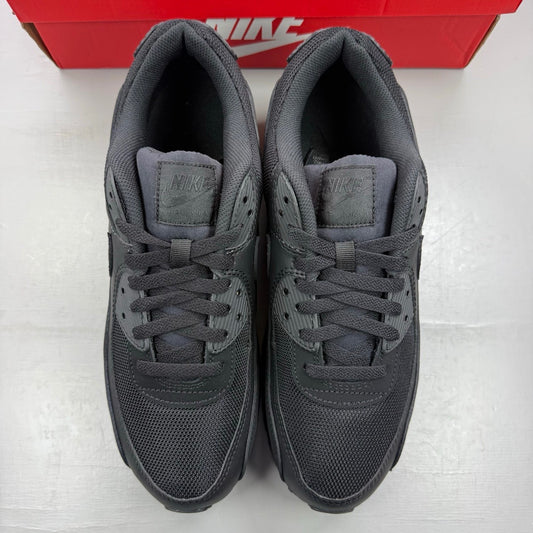 Nike black trainers with Air Max cushioning and subtle logo detailing.