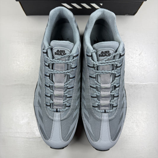 Nike running shoes grey with caution strip detailing and Air Max cushioning.