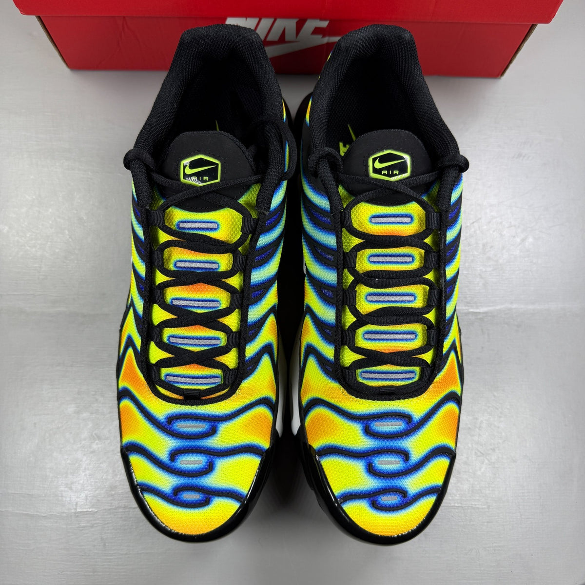 Nike athletic shoes yellow with heat map pattern and black accents.