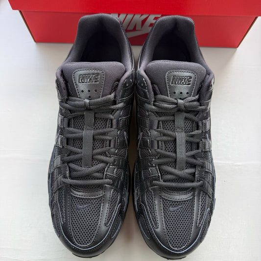 Nike black trainers with mesh upper and signature swoosh logo.