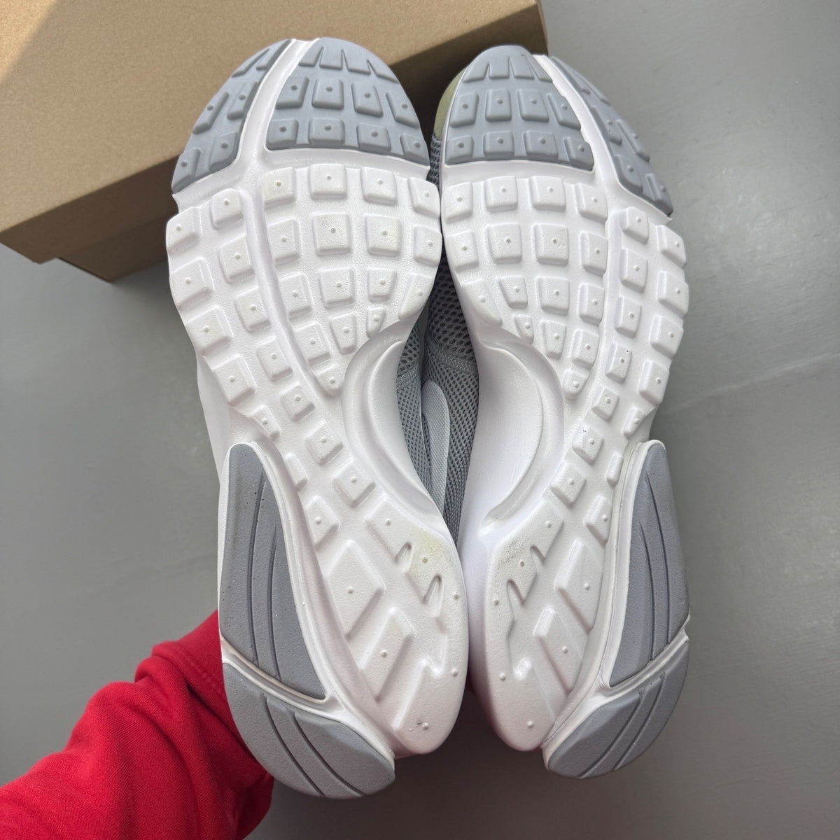 Nike running shoes grey mesh upper with white sole and logo detail.
