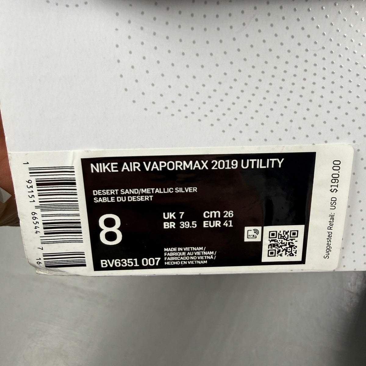 Nike running shoes beige with Air VaporMax sole and utility design.