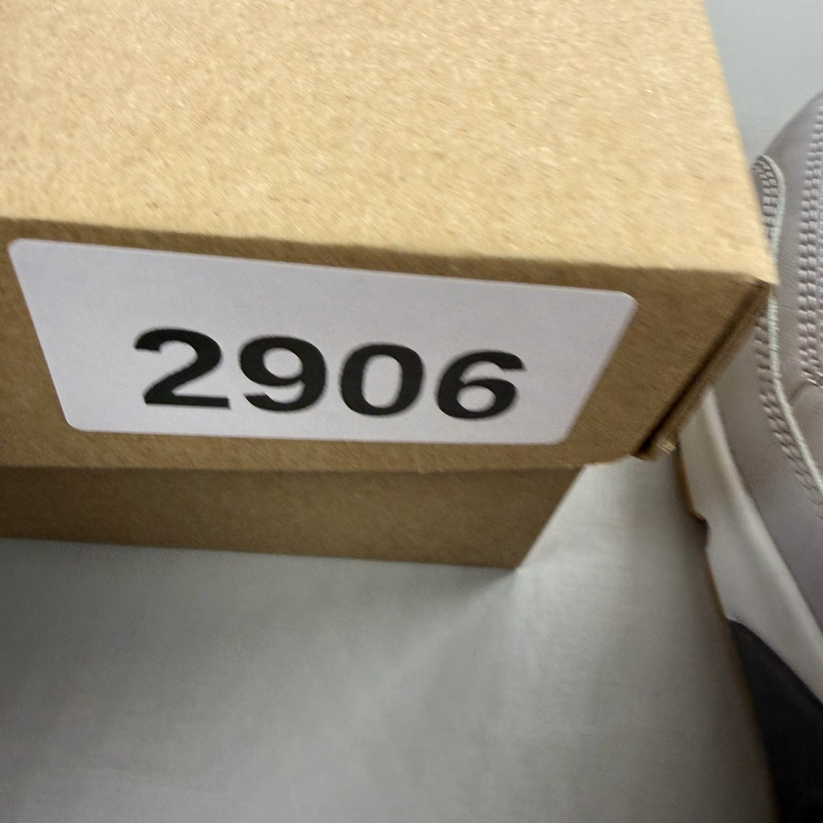 Nike Air Max 90 grey trainers with gum sole and iconic swoosh logo.
