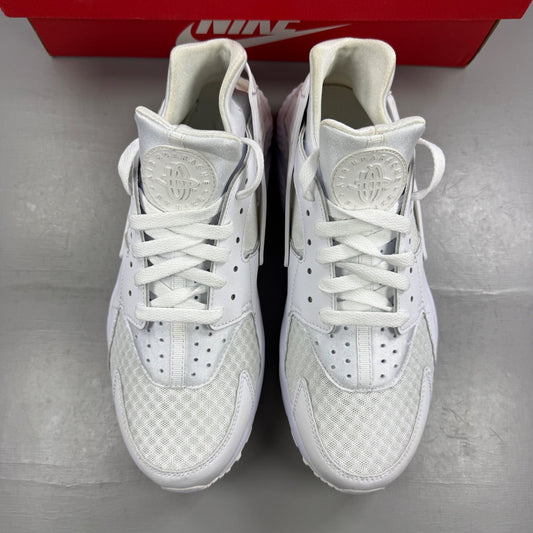 Nike athletic shoes white mesh upper with signature logo and cushioned sole.