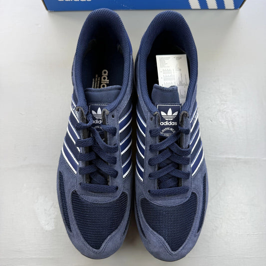 Adidas blue LA Trainer sneakers with white stripes and logo detailing.