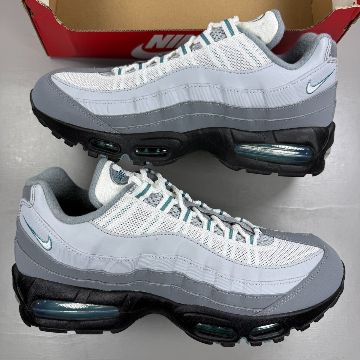 Nike running shoes grey with big bubble sole and reflective detailing.