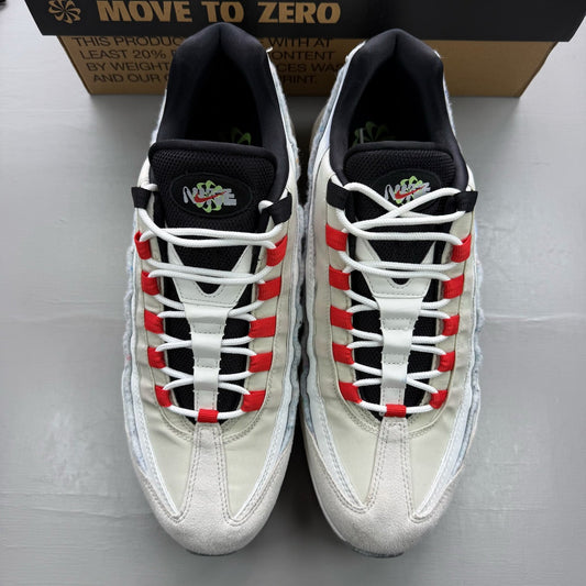 Nike Air Max 95 white trainers with red accents and textured mesh upper.
